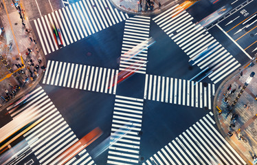 Aerial view of traffic crossing a big intersection in Ginza, Tokyo, Japan at night