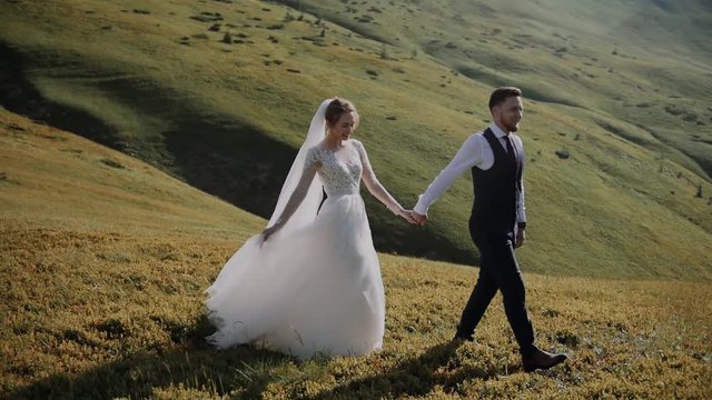Wedding Couple Walks in Mountains 