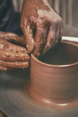 Pottery. The master at the potter's wheel, produces a vessel of clay