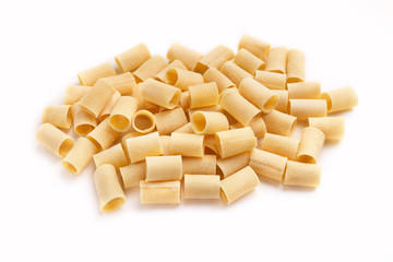 Pile of raw paccheri on white background