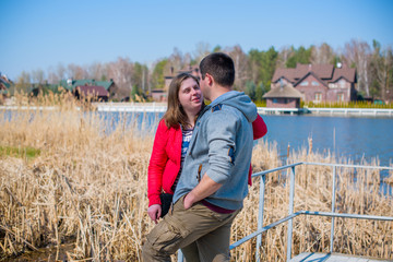 American young couple with overweight walk in park, man and woman together  