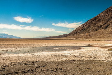 Landscape of salt flats desert in Badwater Basin on a beautiful day of summer, Death Valley National Park, California.