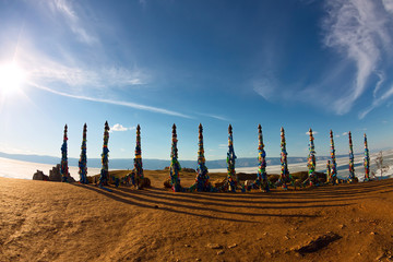 Shaman poles of serge on Olkhon in the sunset with long shadows