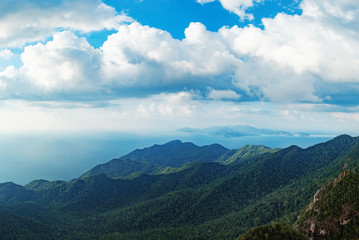 Fototapeta premium Panoramic view of blue sky, sea and mountain seen from Cable Car viewpoint, Langkawi, Malaysia. Picturesque landscape with beaches, small Islands and tourist ships at waters of Strait of Malacca