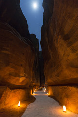  Petra by night with full moon, narrow gorge of the Siq, Jordan