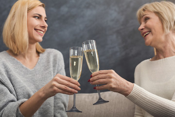 Happy adult mother and daughter together at home