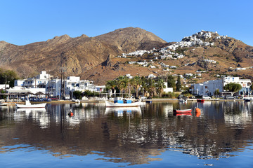 Fototapeta na wymiar Fishing harbour of Livadi with view of mountaintop town of Pano Chora, Serifos Island, Greece