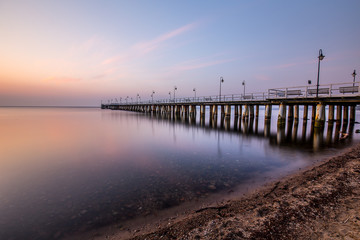 Fototapeta premium Amazing colorful sunrise over the pier in Gdynia Orlowo. Sunrise over the sea.