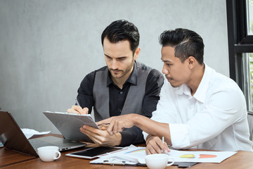 Happy Two business man smile and looking in report in office