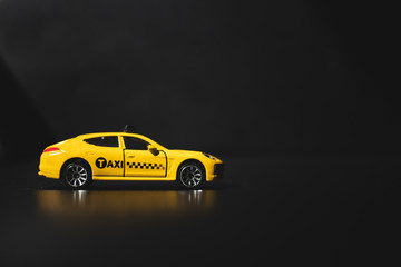 Closeup yellow taxi on dark background