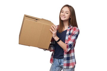 Delivery, relocation and unpacking. Smiling young woman holding cardboard box isolated on white...
