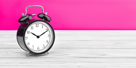 alarm clock on wooden board