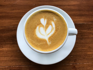 Cup of coffee on wooden table background