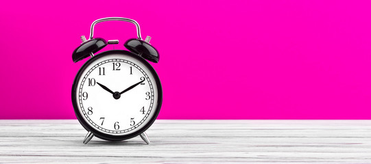 alarm clock on wooden board