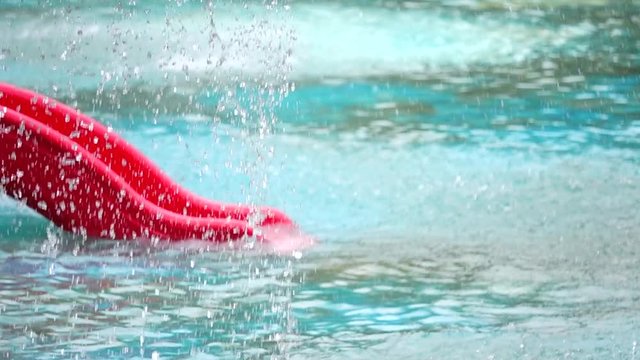 HD 1080 super slow Slider in the water springer spray in the pool	