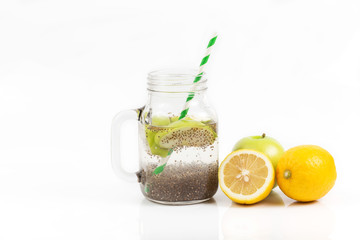 Apple green sliced with chia seeds in glass and fresh apples with lemon on the wooden table, Drink to good health