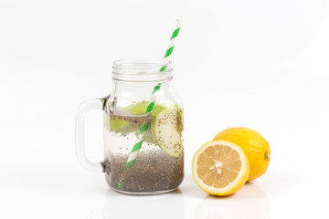 Apple green sliced with chia seeds in glass and fresh apples with lemon on the wooden table, Drink to good health