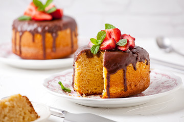 Small Vanilla And Strawberries Cakes With Chocolate Topping