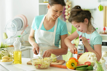 Mom and daughter cook