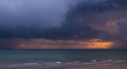 Obraz premium Colorful seascape with thunderclouds and lonely small boat