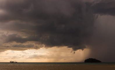 Colorful seascape with thunderclouds and lonely small boat