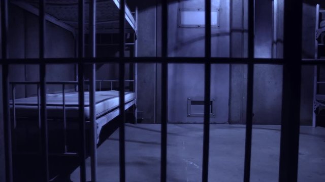 EMPTY JAIL CELL AT NIGHT, SLIDER SHOT