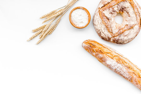 Appetizing Fresh Bread Concept. Baguette And Round Loaf Near Ears Of Wheat On White Background Top View Copy Space
