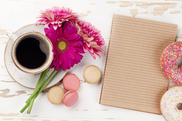 Coffee cup, donuts and gerbera flowers