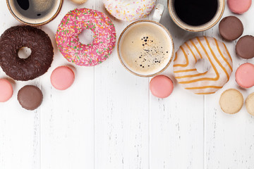 Coffee cups, donuts and macaroons