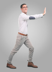 Concerned young man with a gesture of hold - Full body shot