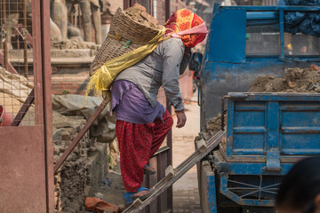 woman carrying heavy basket Bhaktapur Durbar Square