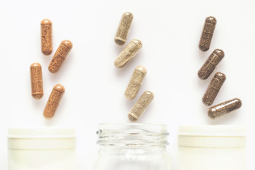 Medicinal capsule spill out of a three plastic bottles