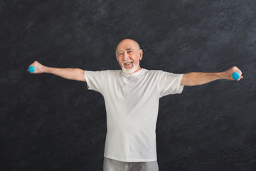 Senior man making exercise with dumbbells