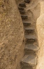 Stone steps leading up through a rock crevice at Bandelier National Monument, New Mexico, USA.