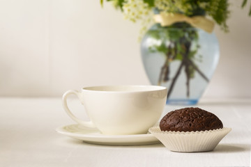 Morning cake and cup of coffee on flower vase background