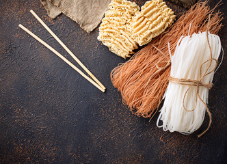 Different Asian rice noodles on rusty background