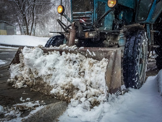 snowplowing tractor removing the snow