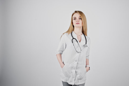 Blonde doctor nurse with stethoscope isolated on white background.