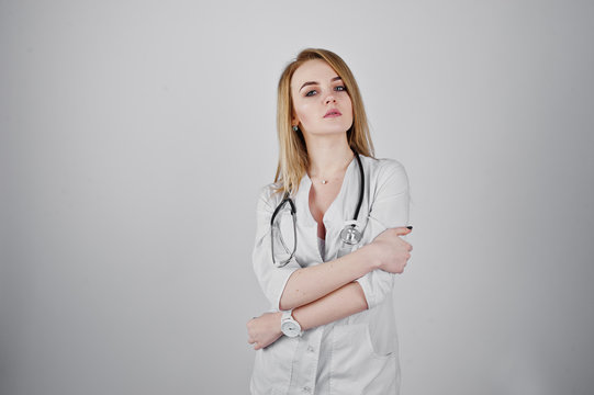 Blonde sexy doctor nurse with stethoscope isolated on white background.