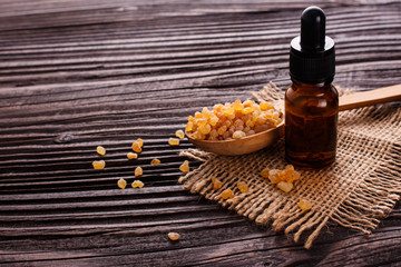 frankincense essential oil on a wooden background