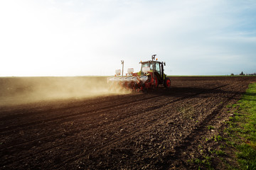 Fototapeta premium Farmer seeding crops at field