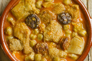 Close up of Spanish callos with chickpeas on an earthenware bowl