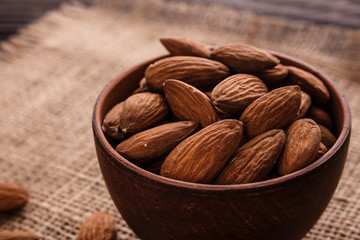 almond essential oil on a wooden background