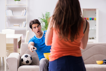 Wife unhappy that husband is watching football