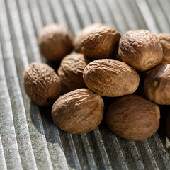 aromatic nutmeg on a gray wooden background