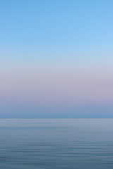 Fototapeta premium Colorful sunset sky and sea with blurred motion.