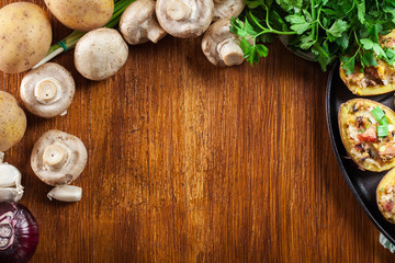 Baked potatoes in jacket stuffed with bacon, mushrooms and chees