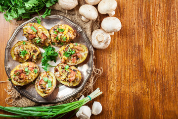 Baked potatoes stuffed with bacon, mushrooms and cheese