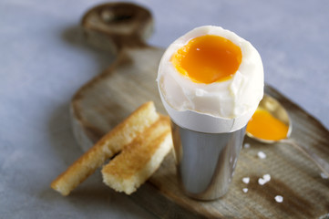 Breakfast. eggs soft-boiled on a gray background.