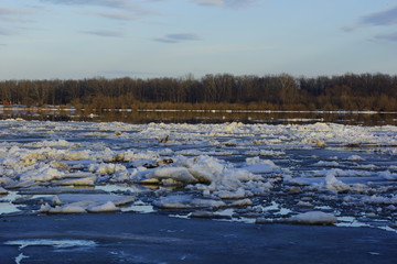 big white and blue pieces of ice and snow. ice drift in the evening sunset sky